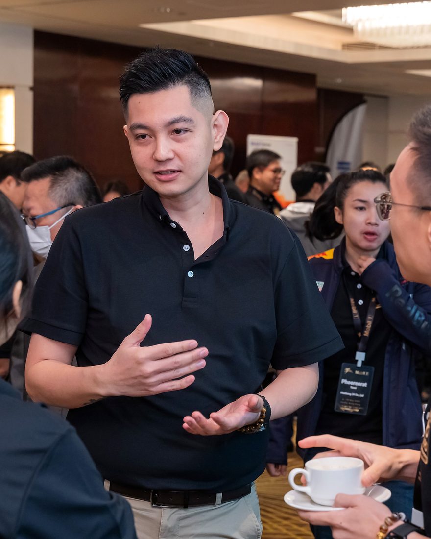 Jayden Khoo mid-conversation at a sales event